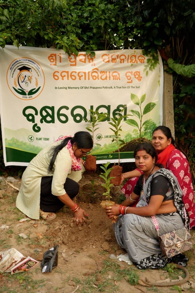 Tree plantation drive with Sri Prasanna Pattnaik Memorial Trust banner